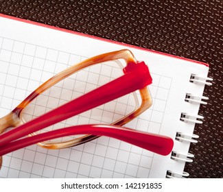 Spectacles and a jotter