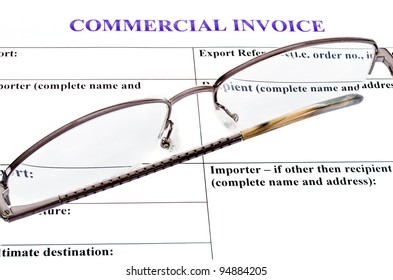 Spectacles Lie On The Form Of Commercial Invoice