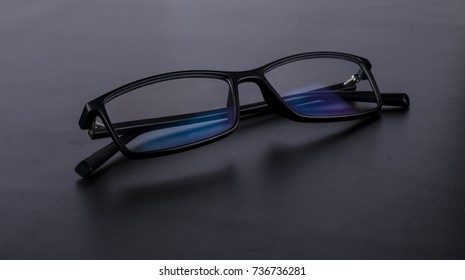 spectacles on a dark background.