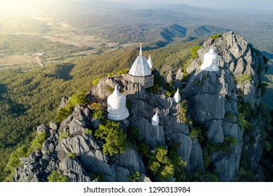 Spectacular aerial view of floating pagodas on the mountain cliff at Wat Chaloem Phra Kiat in Chae Hom District, Lampang province, Thailand.