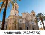Spectacular Cathedral of Cadiz. Roman Catholic church in Cádiz, southern Spain. 	Baroque, Rococo, Neoclassical style. Famous travel destination in South of Spain. Sunset point with orange reflections.