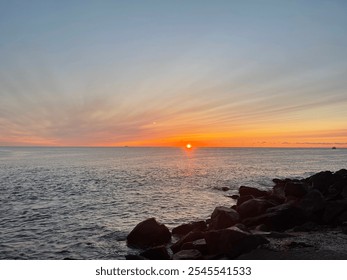 Spectacular Ocean Sunrise with Rocky Shoreline - Powered by Shutterstock