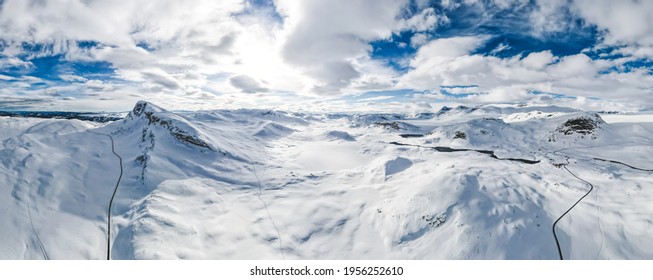 Spectacular Panoramic View Over Snowcapped Mountain Peaks, Ridges And Frozen Highland Tundra In Jotunheimen, Norway.