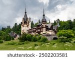 Spectacular Peles Castle situated in Sinaia, Romania. Neo-Renaissance castle in the Carpathian Mountains surrounded by forest. Constructed for King Carol I. Famous travel destination. 