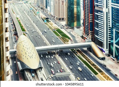Spectacular skyline of downtown Dubai, UAE.  Famous highway with traffic, metro and skyscrapers. Transportation and travel background.