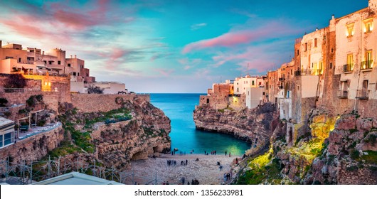 Spectacular spring cityscape of Polignano a Mare town, Puglia region, Italy, Europe. Colorful evening seascape of Adriatic sea. Traveling concept background.
