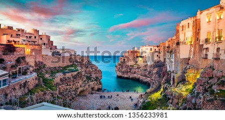Spectacular spring cityscape of Polignano a Mare town, Puglia region, Italy, Europe. Colorful evening seascape of Adriatic sea. Traveling concept background.