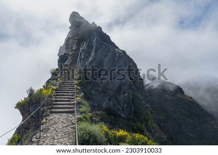 The spectacular 'stairway to heaven' on the dramatic ridge as part of the Pico do Arieiro to Pico do Ruivo hike on the portuguese island of Madeira