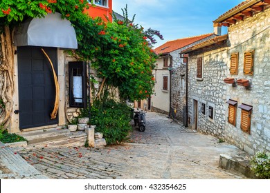 Spectacular stone paved street and restaurant entrance with colorful mediterranean flowers, Rovinj old town,Istria region,Croatia,Europe