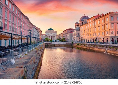 Spectacular summer sunrise in Trieste, Italy, Europe. Gorgeous morning view of Canal Grande di Trieste and Church of Sant'Antonio Nuovo on background. Traveling concept background.
