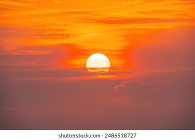 Spectacular sunrise on the horizon with the sea at your feet. Romantic sunrise. Beach sunrises. The sun tries to rise through the clouds in the orange sunrise. Travel and landscape concept. - Powered by Shutterstock