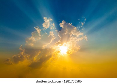 spectacular sunset with sun rays and blue and orange sky - Shutterstock ID 1281783586