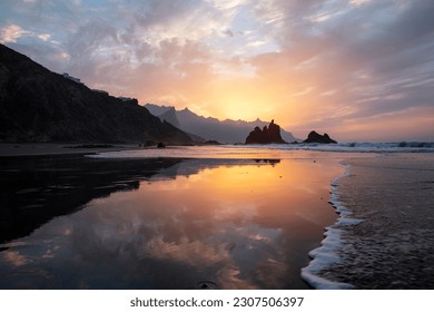 Spectacular twilight reflecting in the calm waves washing the wild Benijo beach or Playa de Benijo, a true representation of beauty in nature, remoteness and isolation, Tenerife, Canary Islands, Spain - Powered by Shutterstock