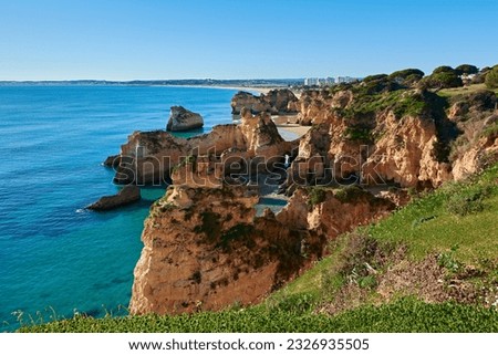 Spectacular view of Alvor village and colorful limestone rocks. Trekking route from Portimao to Alvor. Algarve, Portugal