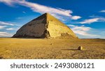 Spectacular view of the Bent Pyramid, built by the Pharoah Snefuru is the first example of a smooth side pyramid seen here against bright blue skies at the Dahshur necropolis near Cairo,Egypt