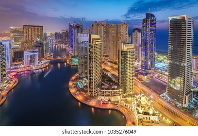 Spectacular view of a big modern city at night. Dubai Marina creek with skyscrapers. Scenic nighttime skyline.