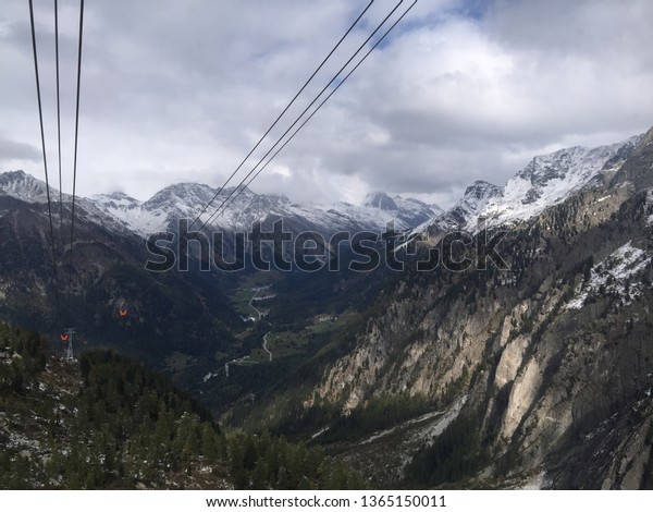 Spectacular view of the Bregaglia Valley\
in Switzerland from the cable car to the Albigna\
dam