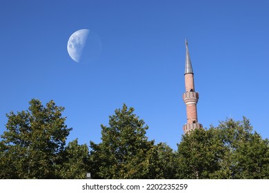 Spectacular View Of The Mosque Minaret, With The Full Moon In The Background.