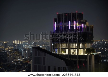 Spectacular view over the city lights of Bankok in Thailand at night photographed from a rooftop bar.