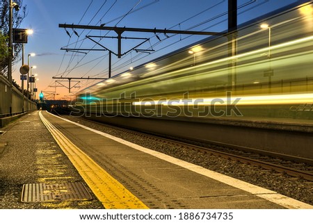 Spectacular view of railway station and colorful sky at Blackrock in the evening, Dublin, Ireland. Long exposure shot of the coming train