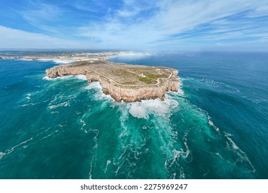 Spectacular view of Sagres peninsula with a lighthouse on the cliff surrounded by the Atlantic Ocean, Sagres, Algarve region, Portugal. - Powered by Shutterstock