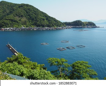 Spectacular view of Sea of Japan coast olf fishing village of Ine in Kyoto prefecture in Japan with old fishing houses, blue sky and turquoise waters of a bay
