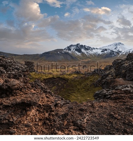 Spectacular volcanic view from Saxholl Crater, Snaefellsnes peninsula, West Iceland. Snaefellsjokull snowy volcano top in far.