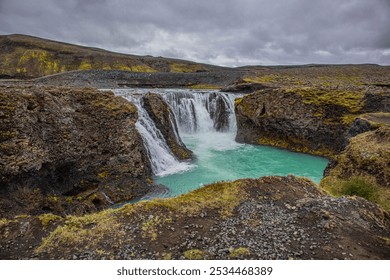 Spectacular Sigöldufoss waterfall in Icelandic Highlans at the iconic F208 route, full of turquoise water flowing from the nearby glacier - Powered by Shutterstock