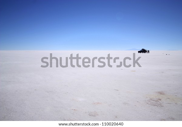 Spectacular white salt landscape with car  in\
the middle of salt desert, Uyuni, in Bolivia near border with\
Chile, south\
America.