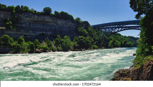 Spectacular White Water Walk with turquoise wild river and the bridge at the Niagara Falls, Canada - Shutterstock ID 1702472164