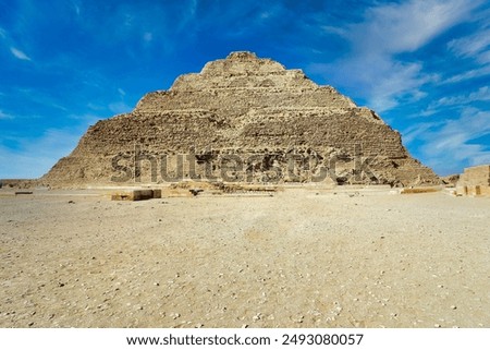 Spectacular wide angle view of the Step Pyramid of Djoser built by Imhotep, the first pyramid in the 3rd dynasty in Saqqara necropolis with brilliant blue skies near Cairo,Egypt