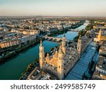 Spectacular Zaragoza city skyline at sunset. View of old town center, Cathedral of Zaragoza and Ebro River. Medieval and historic travel destination in Aragon - Spain. Sunset point, orange reflections