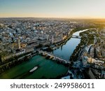 Spectacular Zaragoza city skyline at sunset. View of old town center, Cathedral of Zaragoza and Ebro River. Medieval and historic travel destination in Aragon - Spain. Sunset point, orange reflections