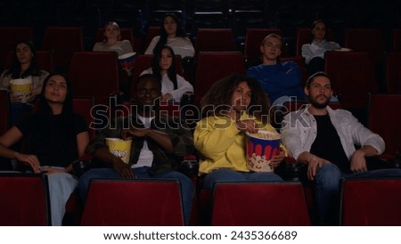 Spectators in the cinema hall in the general plan, the large hall of the cinema is almost filled with spectators, many spectators came to this premiere and filled the hall.