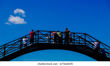 Spectators on a bridge