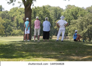 Spectators Stand Around The 18th And Final Hole To Watch A Golf Tournament