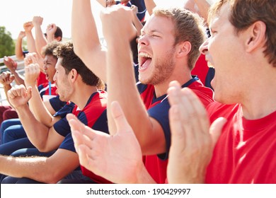 Spectators In Team Colors Watching Sports Event