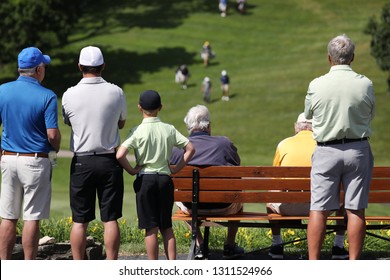 Spectators Watch Players Play In A Golf Tournament