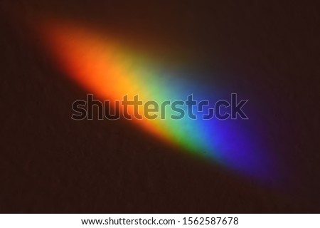 spectral colors in a light beam on a dark background
