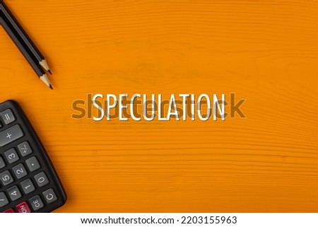SPECULATION - word (text) on a yellow wooden background, a calculator and a pencil. Business concept (copy space).