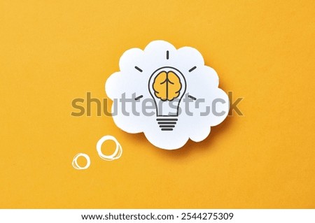 A speech balloon with a light bulb pattern on it. A symbol of the emergence of a creative idea