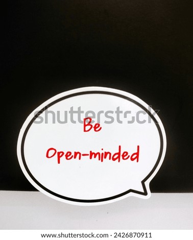 Speech balloon on black copy space with handwritten text BE OPEN-MINDED, being receptive to wide variety of ideas, arguments and information, change incorrect beliefs, learning and personal growth