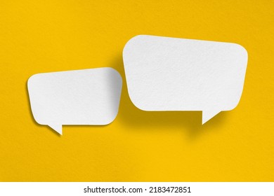 speech balloon shape white paper isolated on yellow background Communication bubbles.