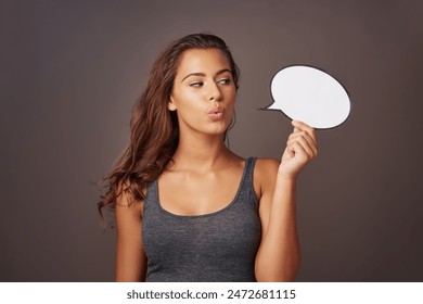 Speech bubble, omg and woman in studio with sign for communication, opinion and feedback. Mockup space, social media and person with poster for information, announcement and emoji on dark background - Powered by Shutterstock