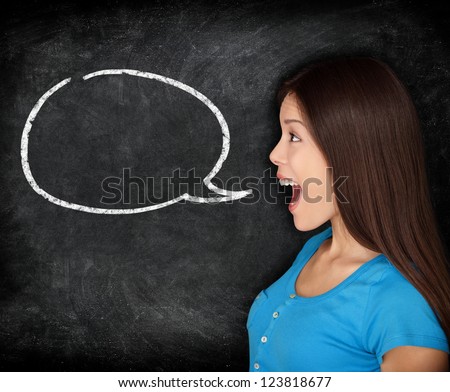 Speech bubble woman student blackboard. Woman talking in profile with black chalkboard texture as background. Funny image of mixed race female college student.
