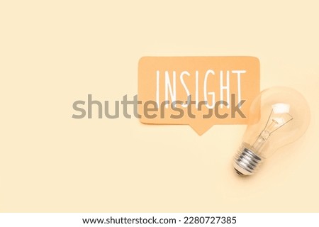 Speech bubble with word INSIGHT and light bulb on beige background