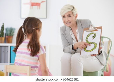 Speech Pathologist With Young Girl Learning The Alphabet