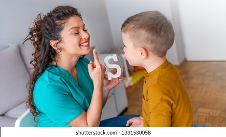 Speech therapist and little patient training articulation. Speech therapist teaches the boys to say the letter S. Shot of a speech therapist during a session with a little boy  - Shutterstock ID 1331530058