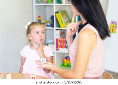 Speech therapist teaches the girl to say the letter - Shutterstock ID 1790955398