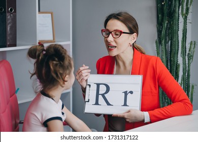 Speech Therapist Teaches The Girls To Say The Letter R. Female Speech Language Therapist Teaching Preschool Kid Sound Pronunciation, Stuttering Cute Child Having Stutter.